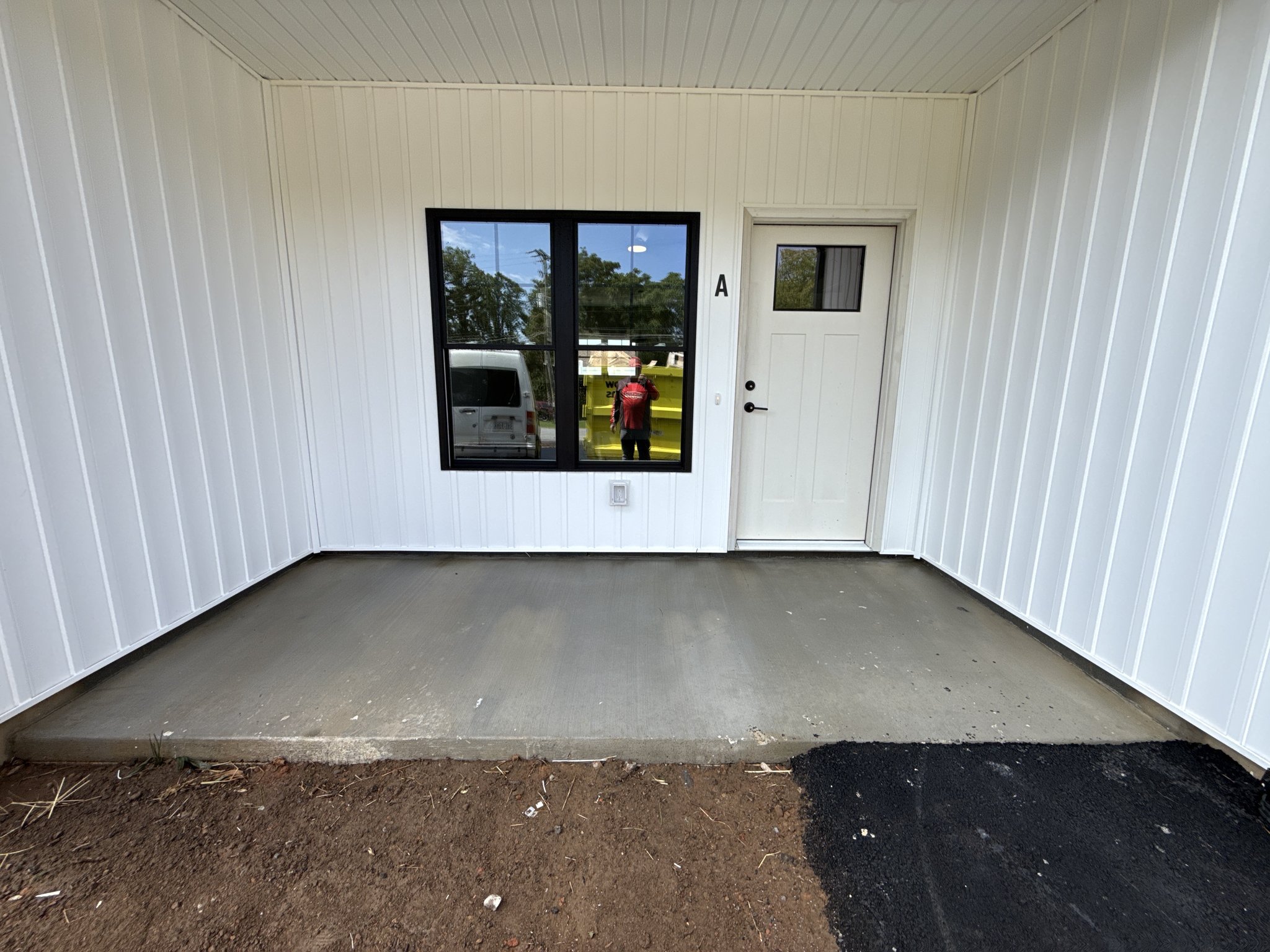 Covered entry porch with clean, even concrete after new construction cleaning