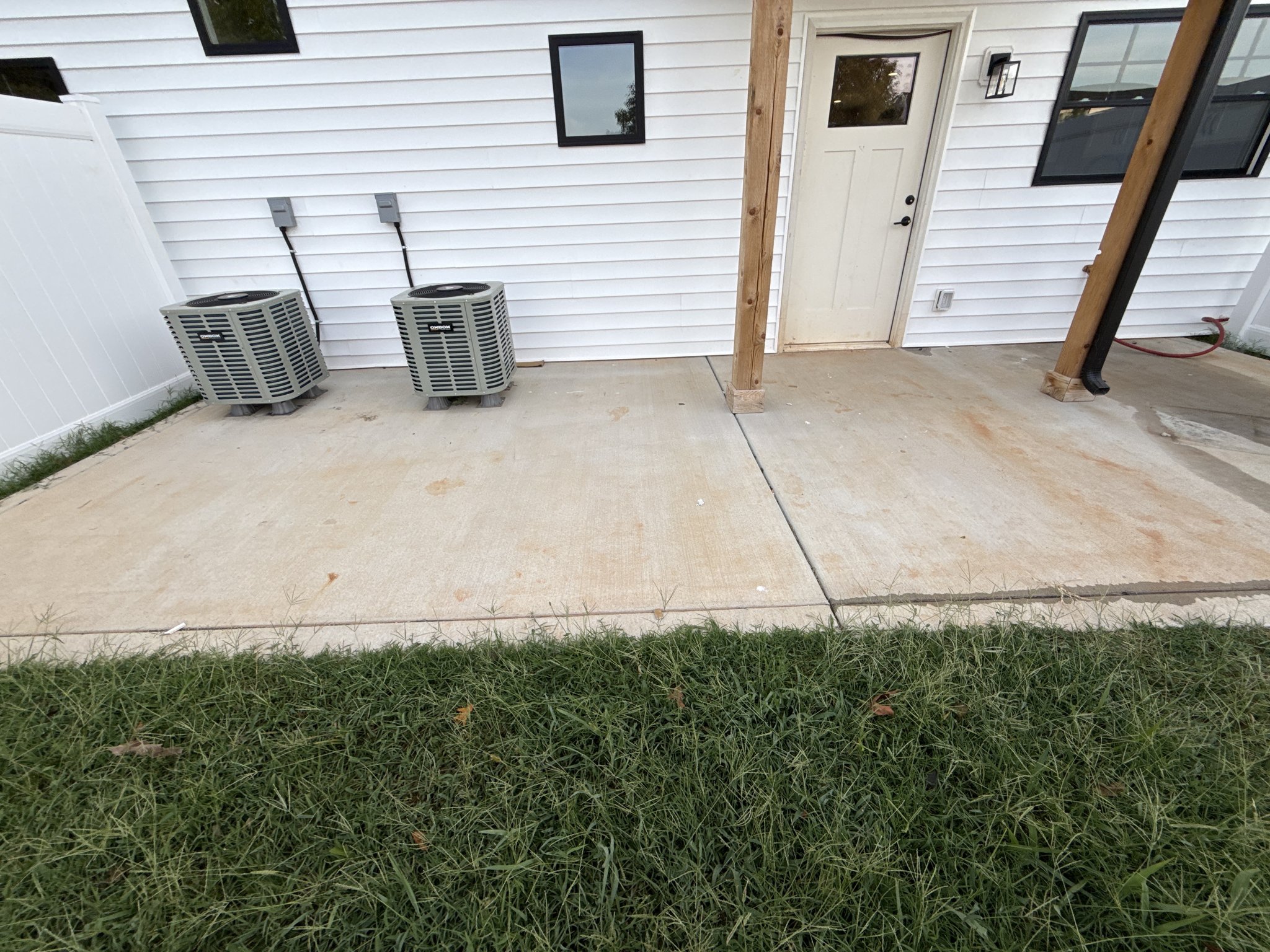 Red clay staining across a new rear patio before new construction cleaning in Lynchburg, VA