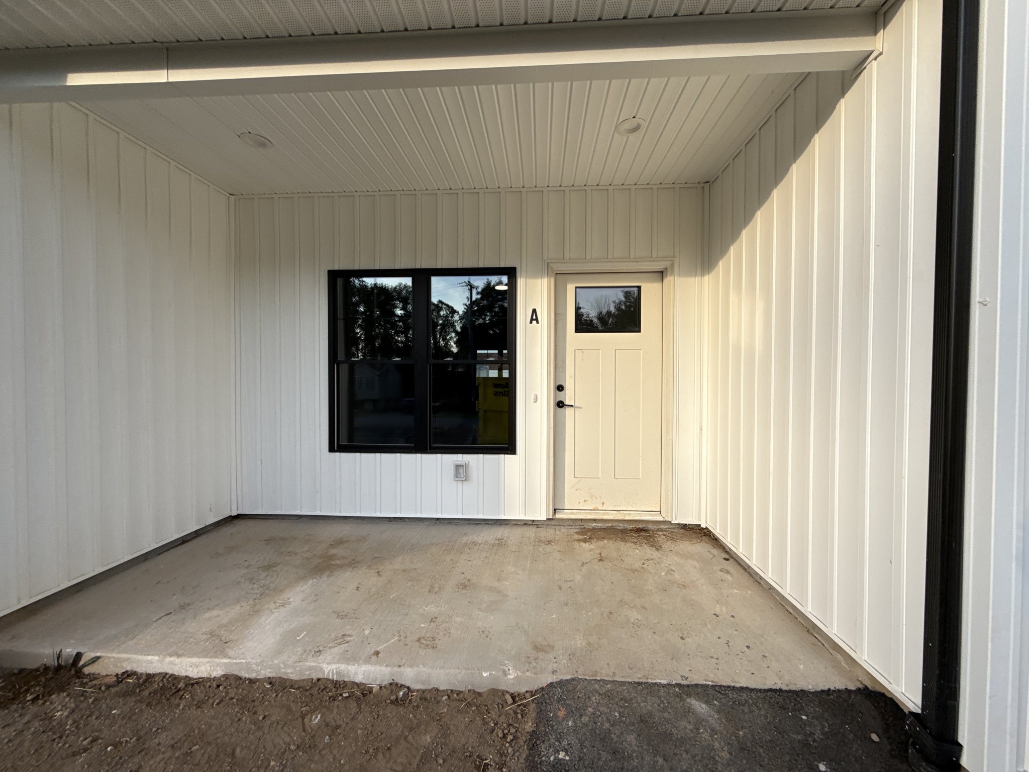 Covered entry porch with construction soil on the concrete before cleaning in Lynchburg, VA