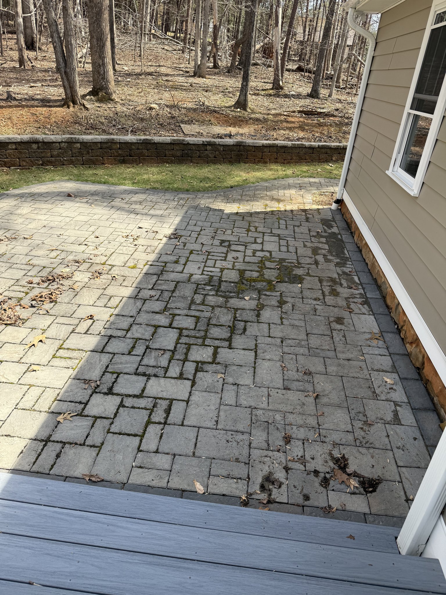 Dirty, weathered back paver patio before restoration in Huddleston, VA