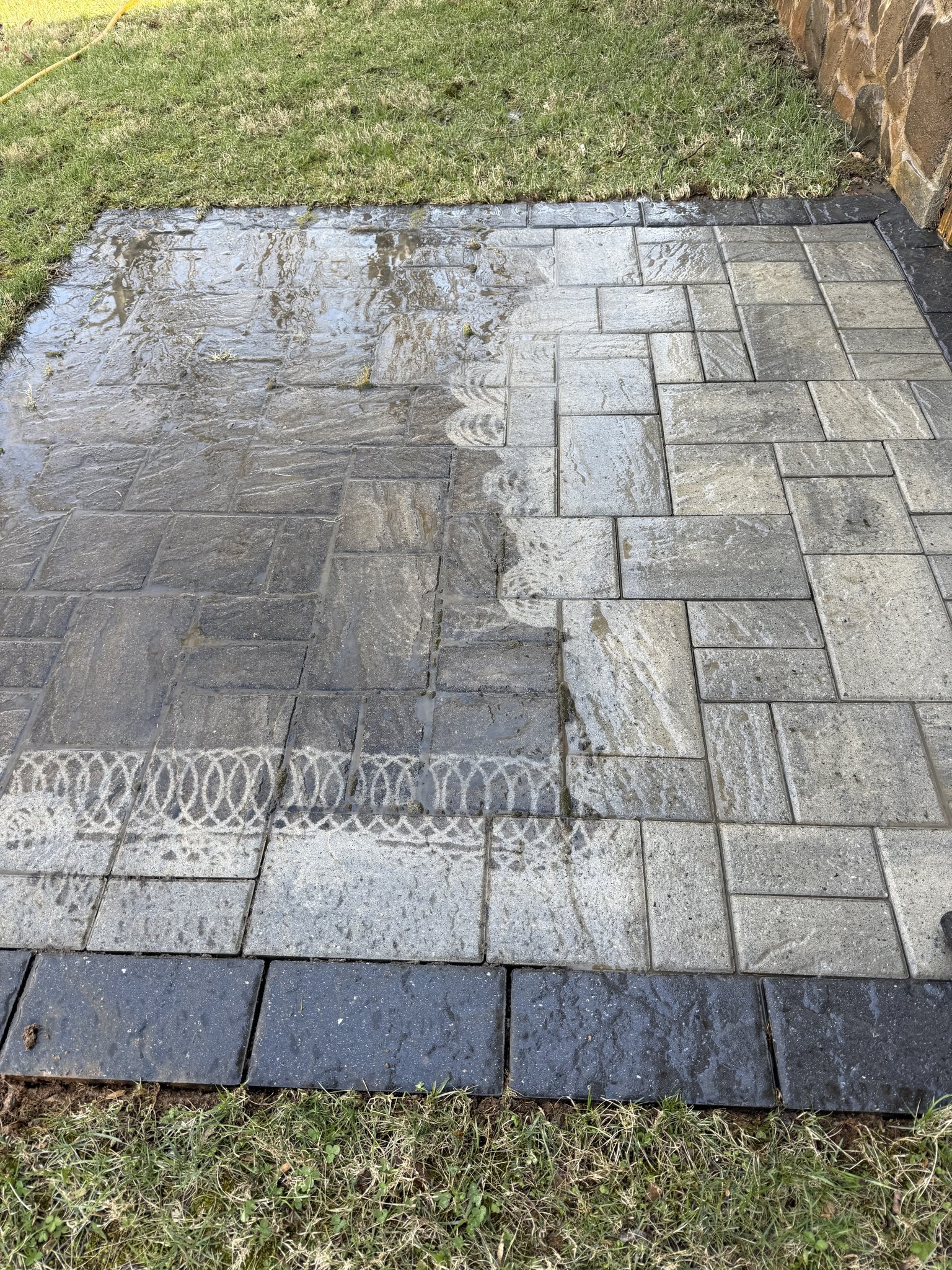 Half-cleaned paver patio showing dramatic before and after contrast in Huddleston, VA