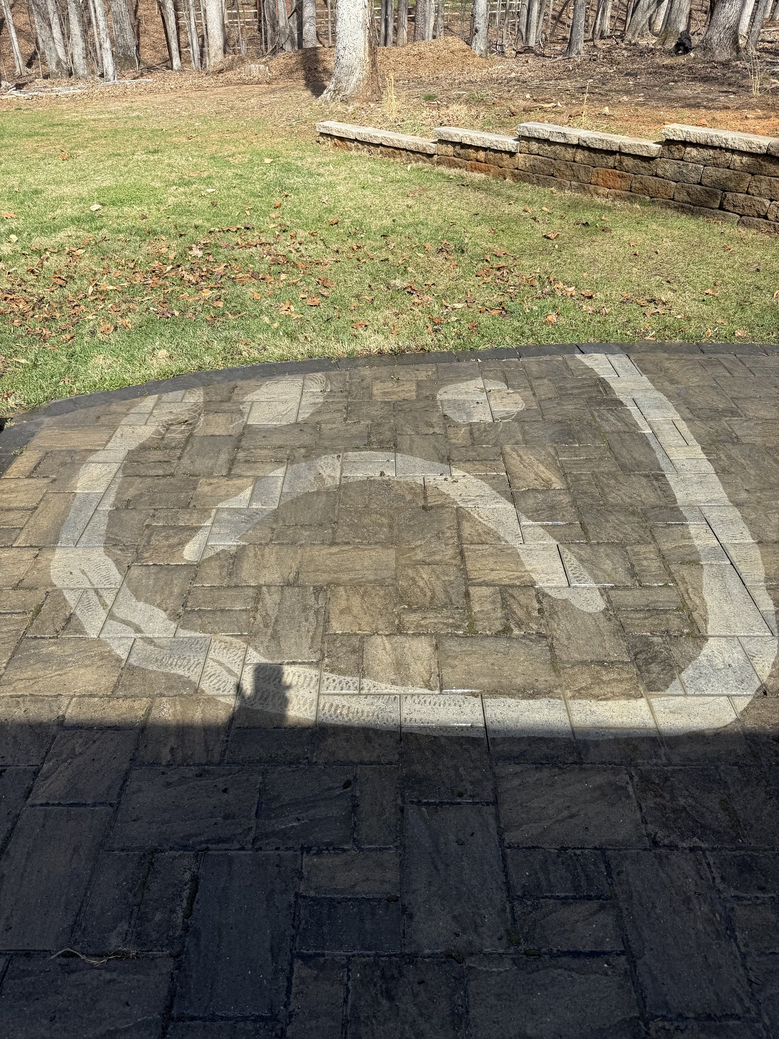 Smiley face drawn in the grime during paver cleaning