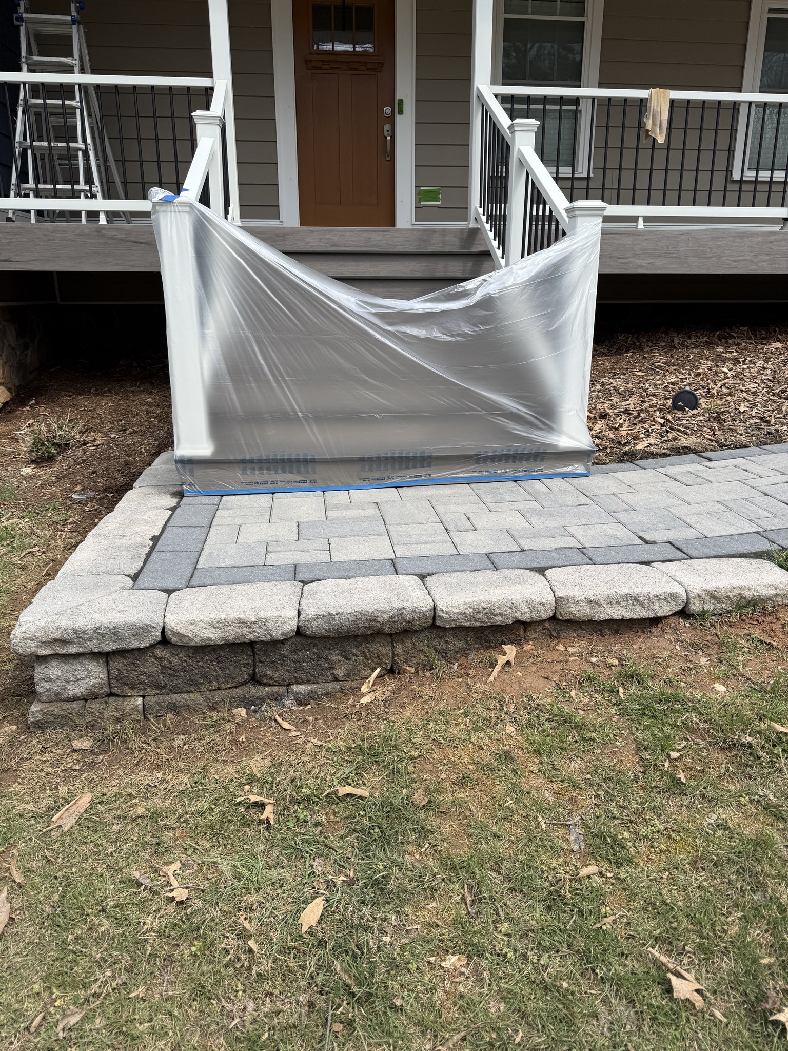 Porch and siding masked off before paver sealing in Huddleston, VA
