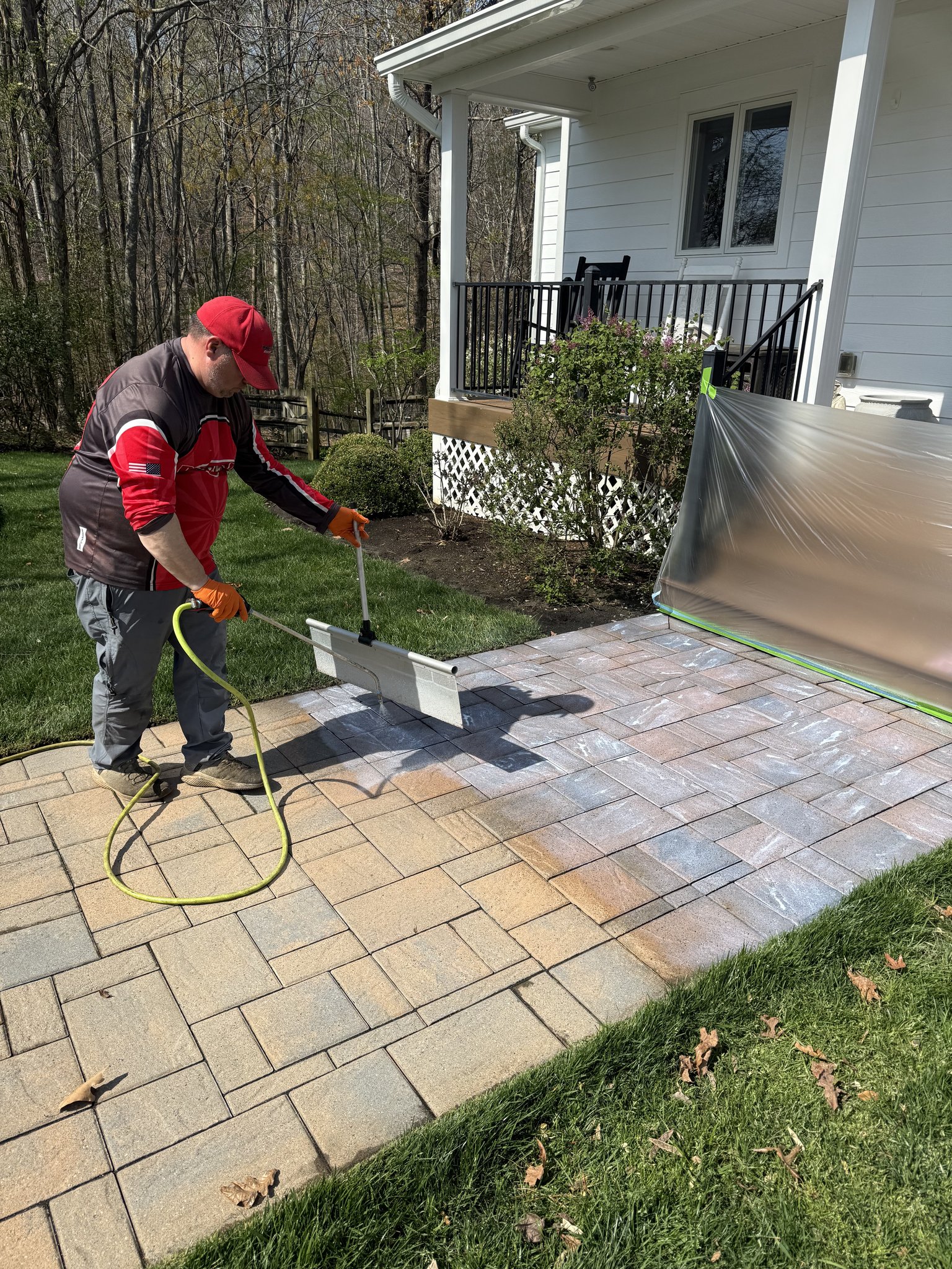 Pro-Shine Softwash technician applying paver sealer with an applicator pad in Union Hall, VA