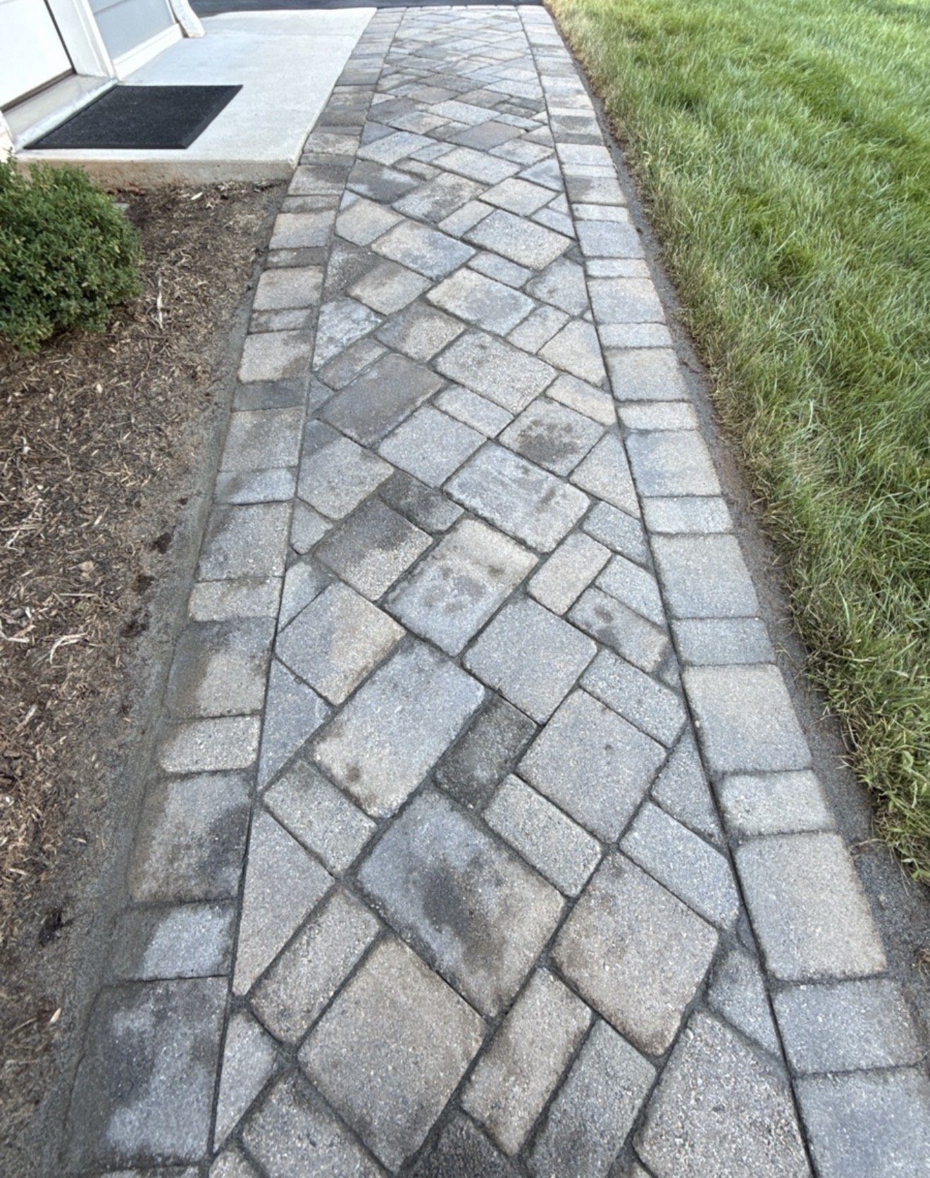 Close view of the paver pattern and new fieldstone joint sand at the door landing