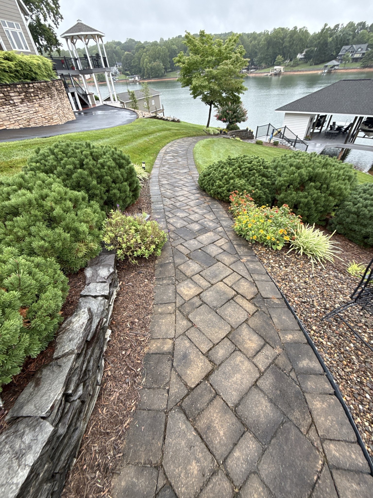 Paver walkway curving down the lawn toward Smith Mountain Lake before cleaning