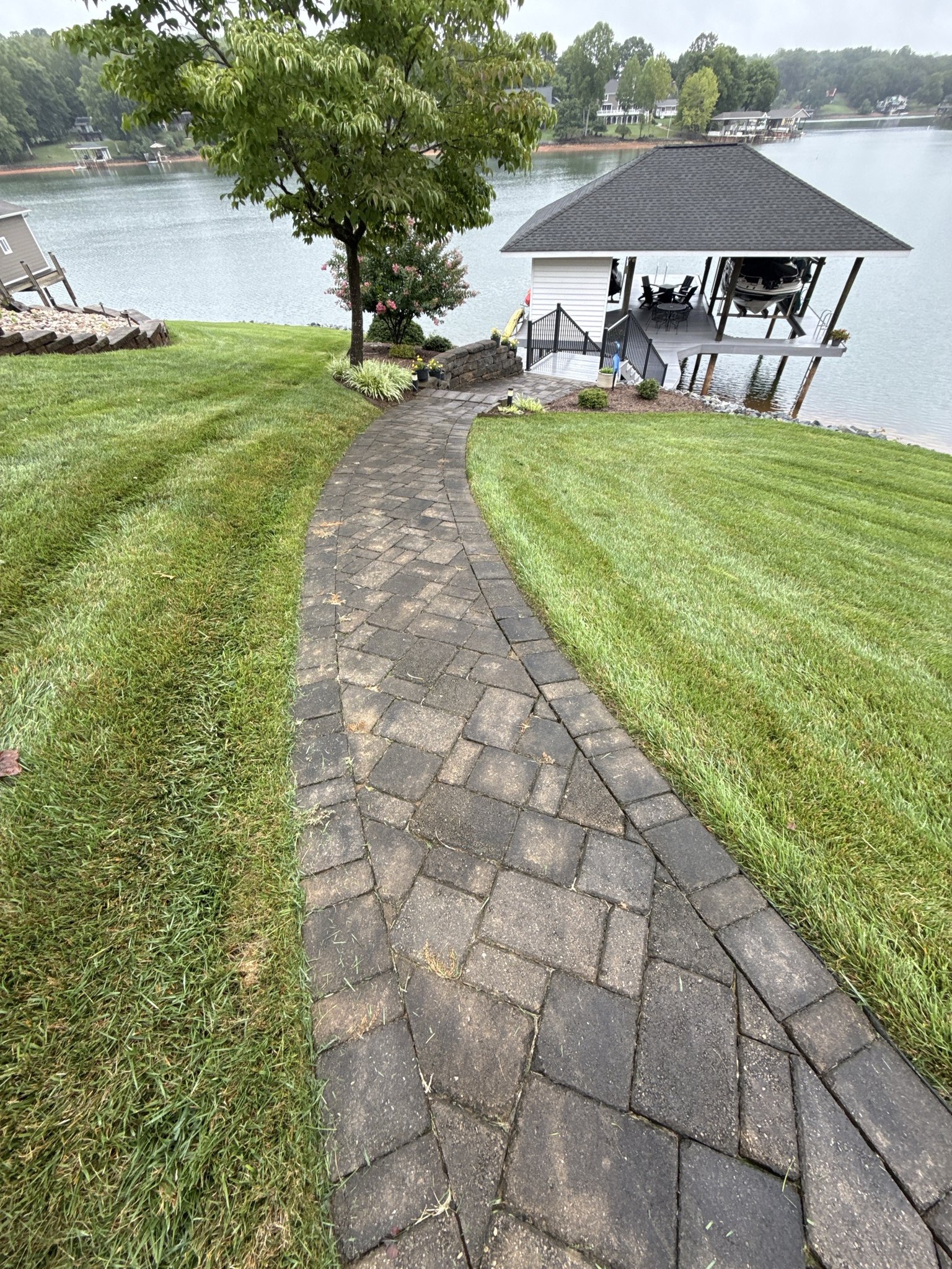 Dirty paver walkway leading down to the dock and boathouse at Smith Mountain Lake