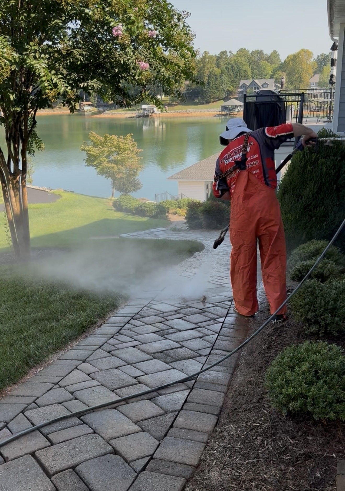 Pro-Shine Softwash deep cleaning the paver walkway above the lake in Huddleston, VA