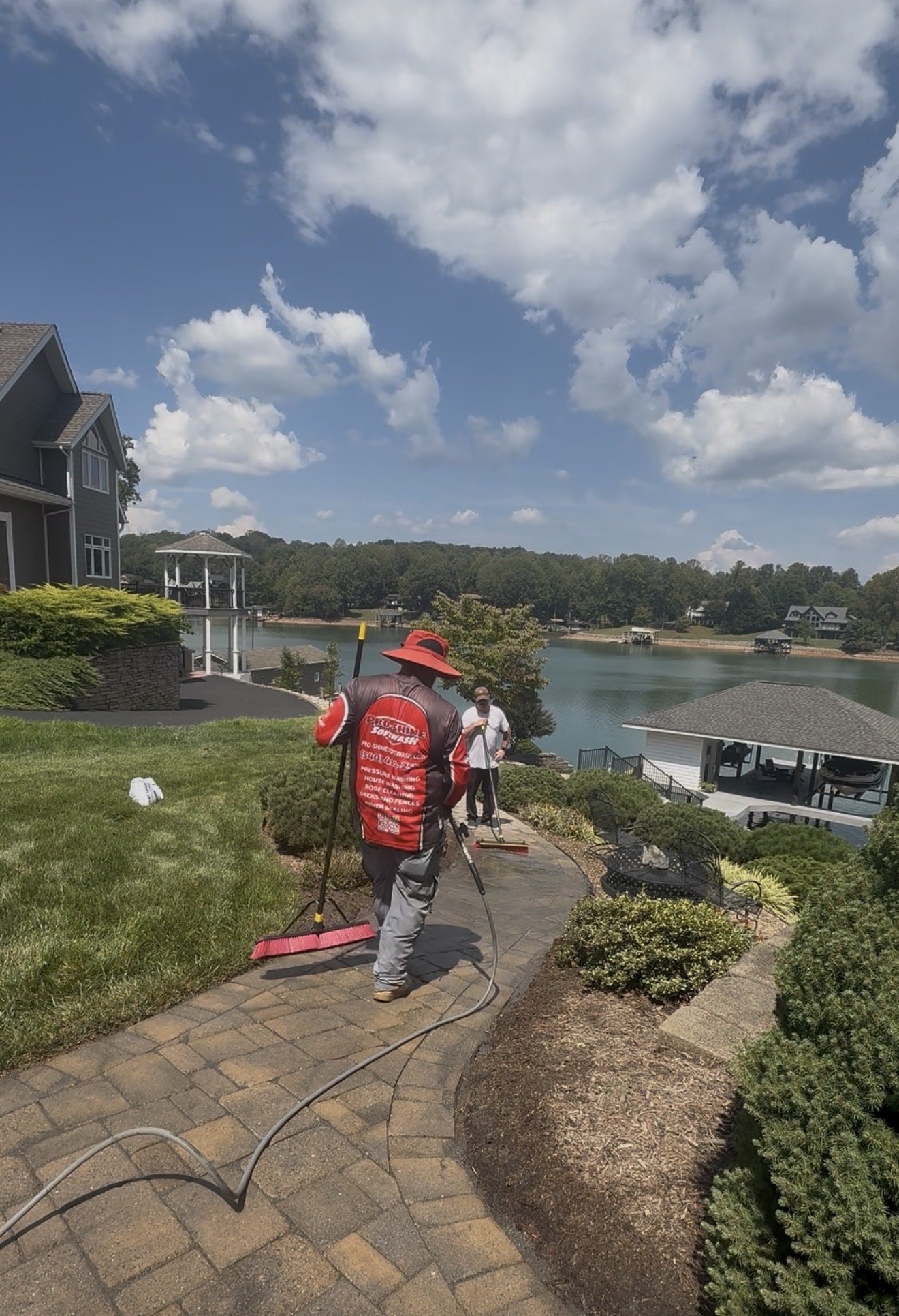 Sweeping new joint sand across the paver walkway at Smith Mountain Lake