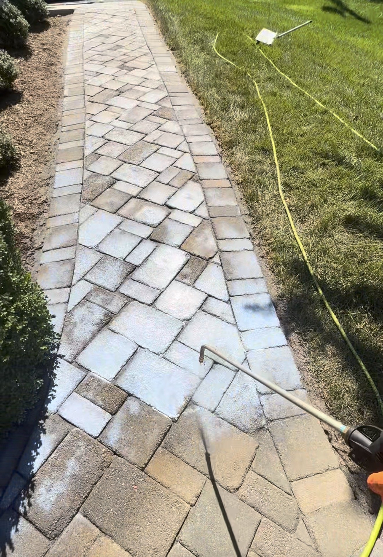 Applying Trident Cyclone sealer to the paver walkway in Huddleston, VA