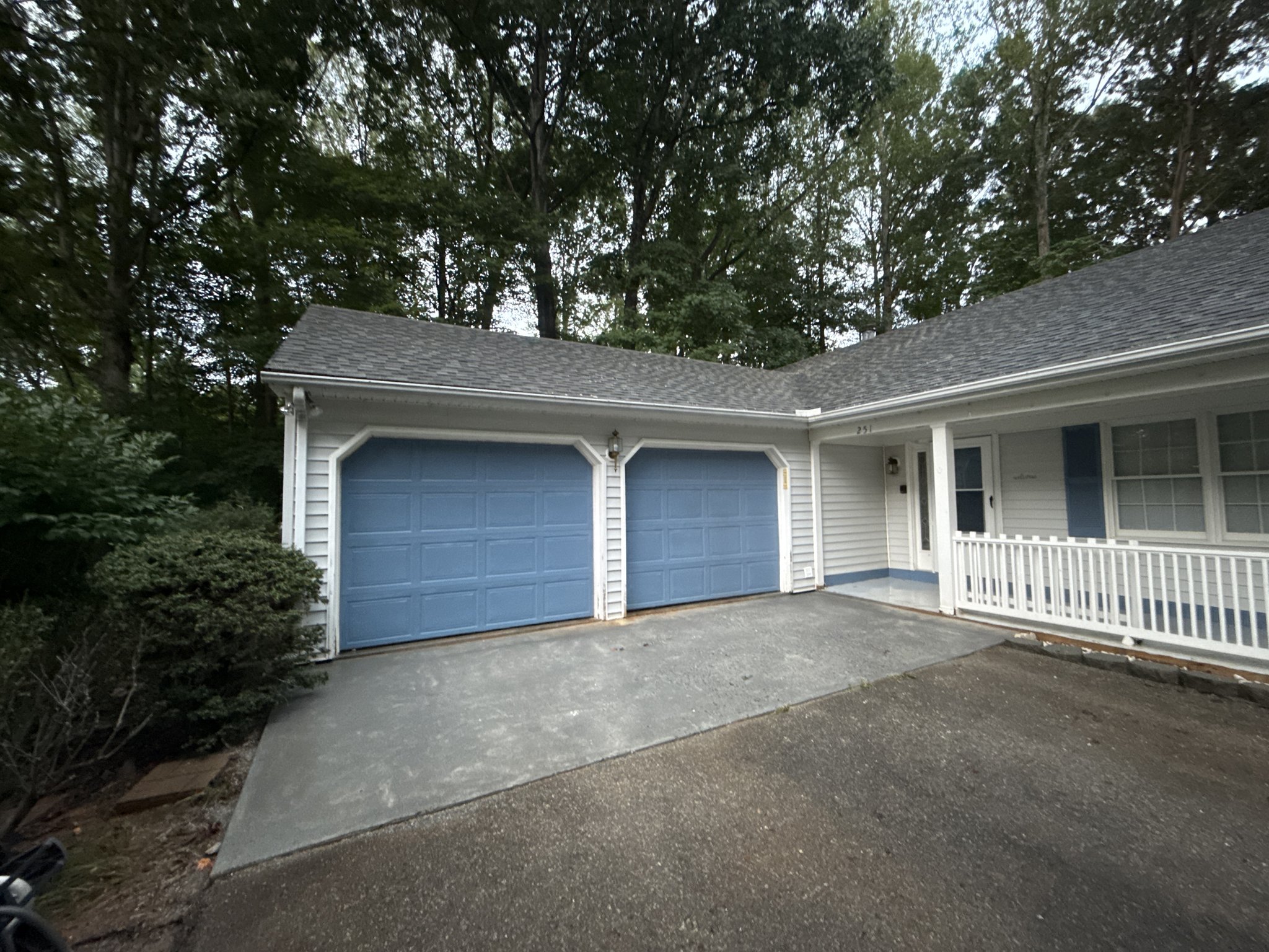 Front of home with freshly cleaned roof over the garage and porch