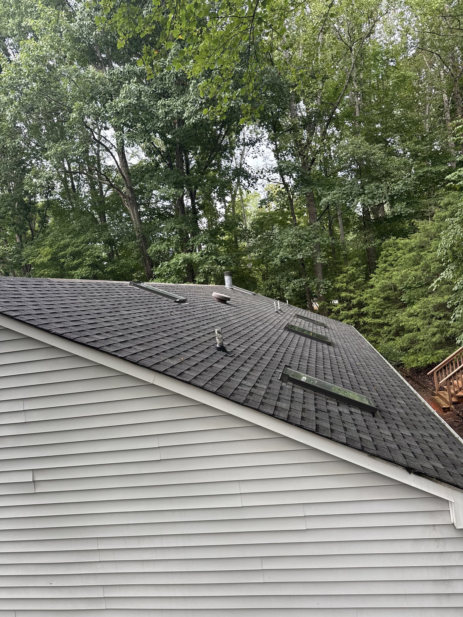 Uniform shingle color restored across the back slope and skylights