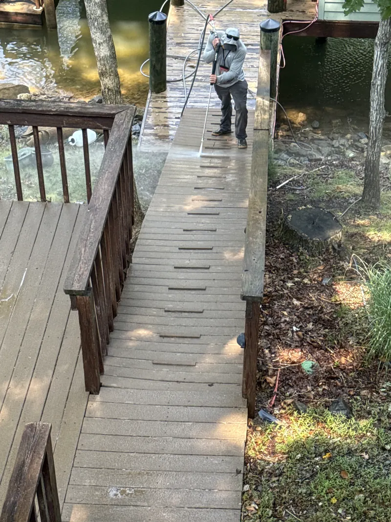 Cleaning the ramp boards leading down to a dock at Smith Mountain Lake, VA