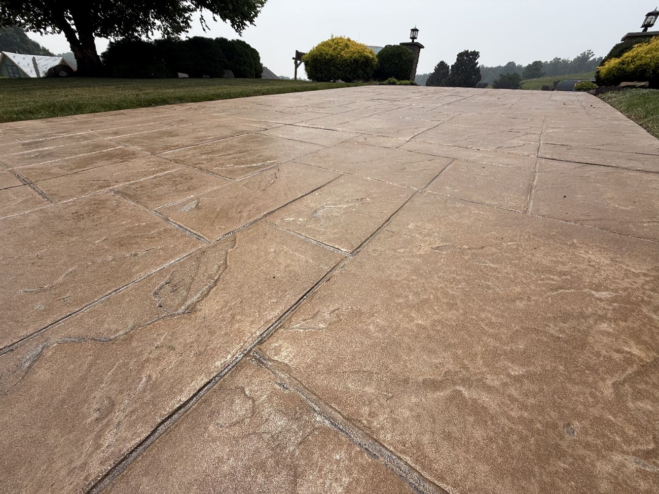 Sunlight sparkling on freshly sealed stamped concrete
