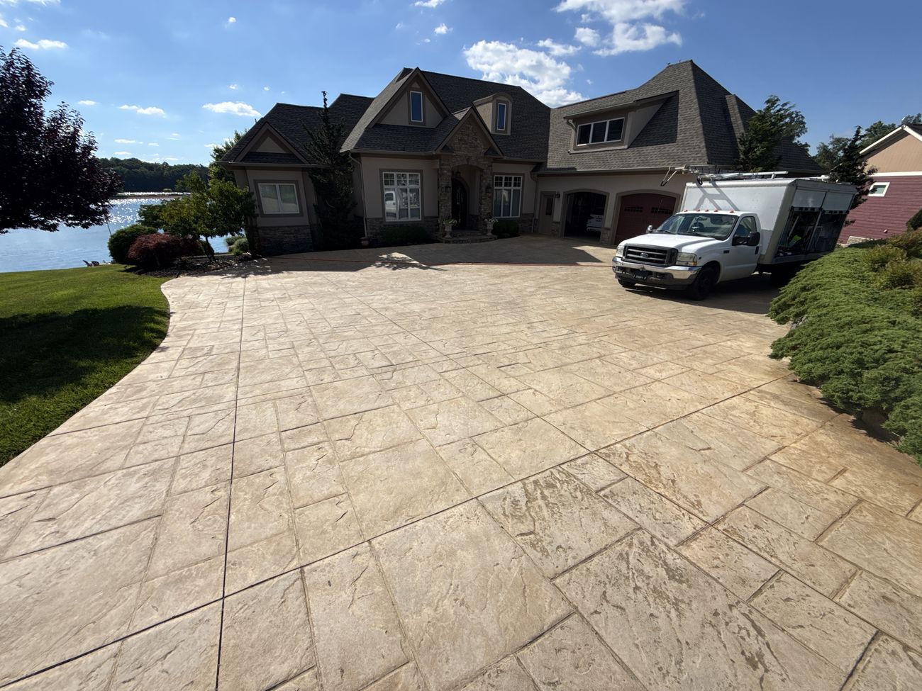 Faded stamped concrete driveway before restoration in Moneta, VA with Pro-Shine Softwash truck on site