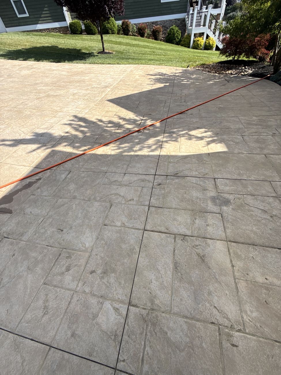 Close-up of faded, worn stamped concrete before restoration