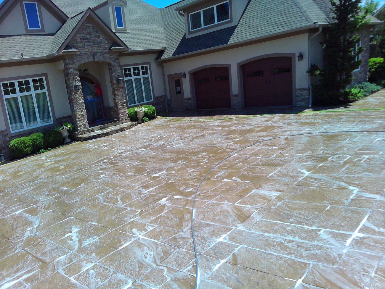Cleaning solution dwelling on stamped concrete driveway during deep clean