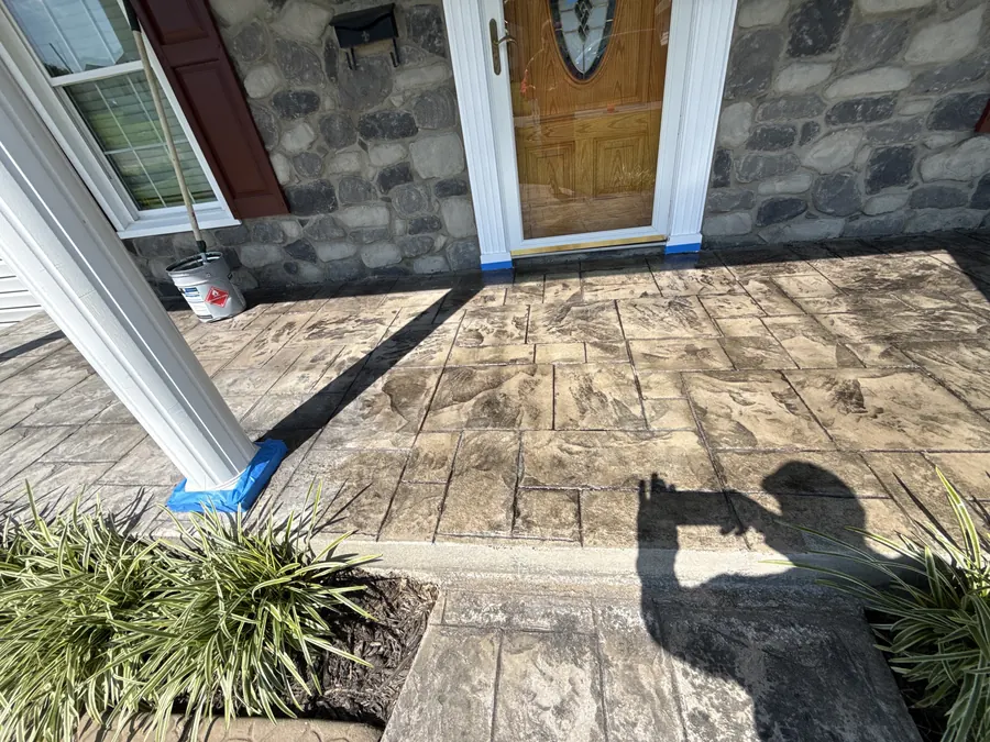 Masking around a door threshold and column before sealing stamped concrete in Rocky Mount, VA